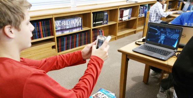 CCISD/Courtesy Photo - S.C. Lee Junior High student Tyler Price uses his phone as a light saber as part of a lesson in computer coding as part of the national Hour of Code event.
