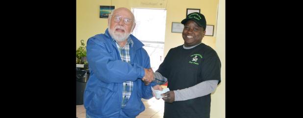 CCLP/LYNETTE SOWELL - Sandor Vegh with the Copperas Cove Optimist Club presents a $50 check from the group to Patrick Richardson, director of the Copperas Cove Soup Kitchen.