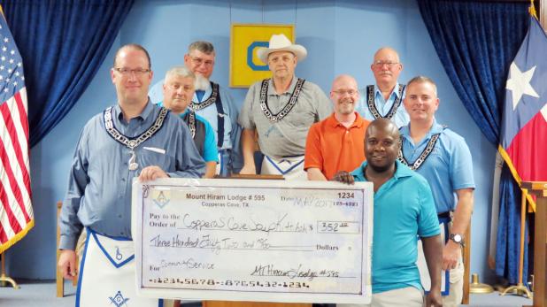 CCLP/DAVID J. HARDIN Mt. Hiram Masonic Lodge #595 members present a $352 check to Patrick Richardson of the Copperas Cove Soup Kitchen. The money was raised during a spaghetti dinner that was held at the lodge in April. On the left is Jim Johnsen, fundraising committee chair, and on right is Patrick Richardson.