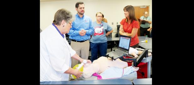 CCLP/BRITTANY FHOLER - Sylvia Ferril, RN, practices ventilating on a SimMan at the RQI implementation event held Thursday morning at Coryell Memorial Healthcare System.