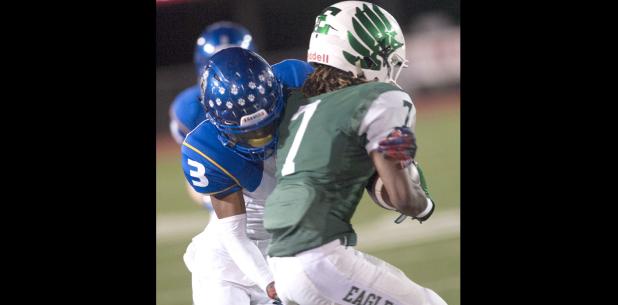 CCLP/DAVID MORRIS - Cove senior defender Tariq Anthony tackles Ellison senior wide receiver X’Zavier Green during the Bulldawgs’ 38-3 win over the Eagles on Oct. 6.