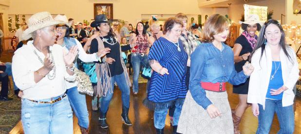 File Photo - The crowd kicks up their heels at last year’s Wild West Night held by the Fort Hood Spouses’ Club. This year’s event is set for March 3 and will help raise funds to benefit local charities and provide student scholarships.