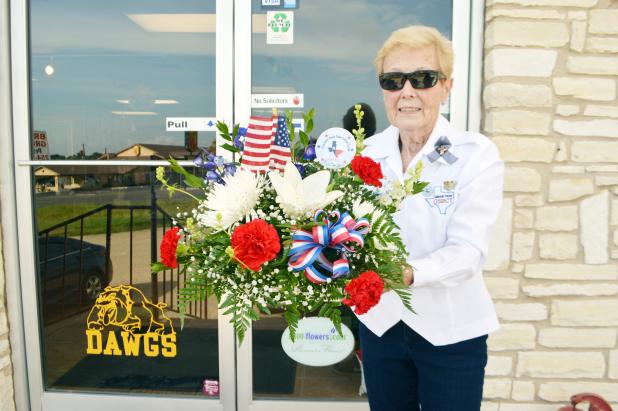 Trudy Bolton leaves A&L Florist on Wednesday morning with a flower arrangement donated by the shop for the funeral of Arthur McClanahan, an unaccompanied veteran who served in the Air Force from 1981-1983. 