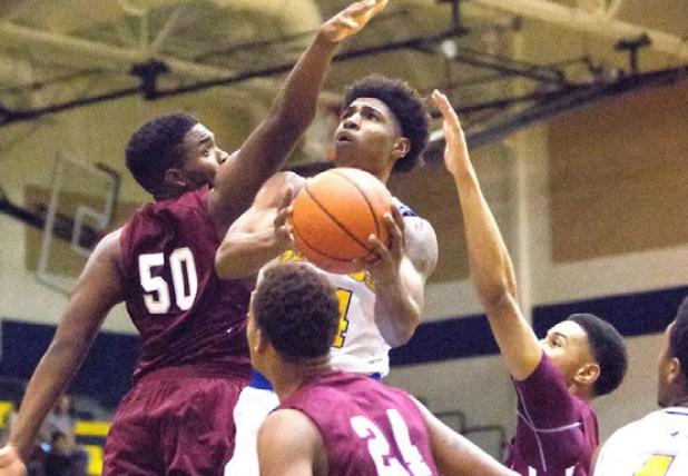 Cove senior Rashard Odomes is smothered by the Killeen defense as he goes up for a shot on Tuesday at Bulldawg Gymnasium. The Dawgs rallied late but were unable to overcome the Roos, eventually falling 72-69. Cove (15-10, 2-3) falls to fifth place in the district behind Killeen (3-3), Shoemaker (3-2), Elliosn (4-1) and Harker Heights (4-1).