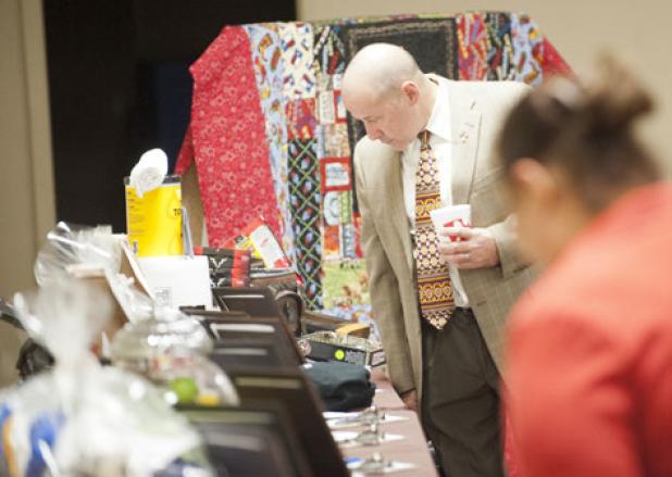 Supporters of Cove House Homeless Shelter browse through more than a dozen
raffle items during the fourth annual fundraising banquet.