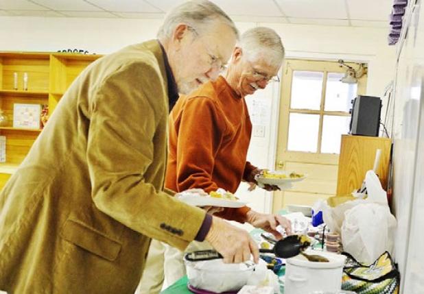 CCISD board members Doug Cook and Bob Weiss help themselves to breakfast at Halstead Elementary on Wednesday morning.