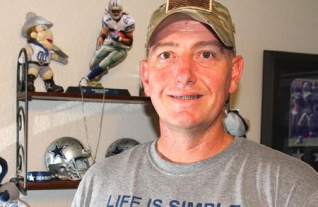 Sfc. Donald Vess holds his challenge coin that serves as his membership card to the Professional Football Ultimate Fan Association. Vess was inducted into the PFUFA last week during the Pro Football Hall of Fame enshrinement ceremony festivities in Canton, Ohio.