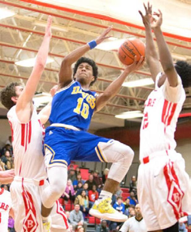 Cove junior Devante Robinson shoots between two Belton defenders during their 59-40 win. Cove is in a three-way tie for third place at 3-3.
