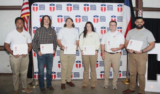 CTC aviation graduates stand proudly after receiving their wings, celebrating years of rigorous training and the beginning of their professional aviation careers.