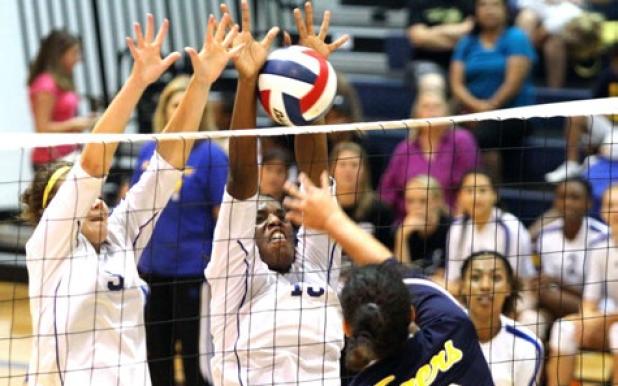Copperas Cove’s Chyanne Chapman blocks the shot of Stony Point’s Annika Bijou as Shana Young leaps to help the Lady Dawgs swept the Lady Tigers 25-19, 25-10, 25-17 on Friday in Round Rock.