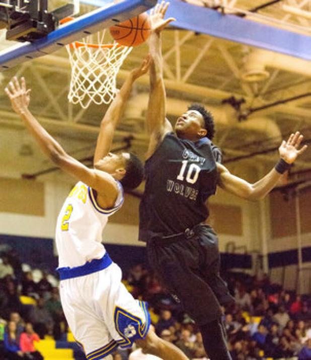 Copperas Cove senior Erick Braddock has his shot blocked from behind by Shoemaker junior Aaron Warren during their District 12-6A contest on Tuesday. The Grey Wolves pulled off the 59-51 upset of the No. 22 Dawgs.