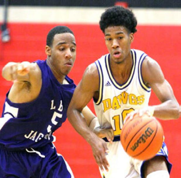 Copperas Cove junior point guard Devante Robinson races past LBJ defender Scott Jabrell during the Dawgs’ 59-44 win. The Dawgs went on to win the tournament undefeated at 5-0.