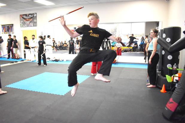 CCLP/PAMELA GRANT  Xander Bickford executes a 360-degree jump spinning kick while throwing and catching his nunchaku. Bickford plans to perform the weapons form at a competition in Wales later this year.