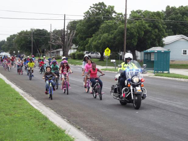 After an assembly on bicycle safety, Hettie Halstead student got the opportunity to ride their bikes around the block with police escort.
