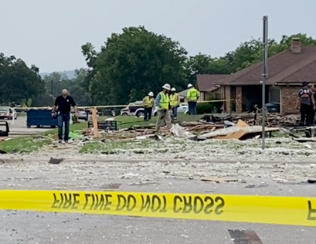 A crew walks through the debris left after a home on East Blancas Drive exploded in June 2024.