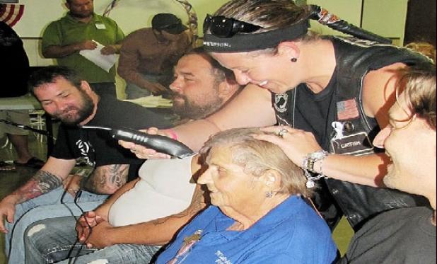 Jerri Jeske has her head shaved after raising $2,000 for the family. Rocky Hughes, Christian Dillon, Daniel Dour, Skip Kelly and Josh Watson each had their heads shaved after reaching the team goal.