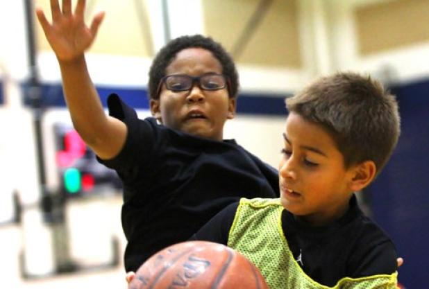Tashaun Brown, 8, defends Ben Izquierdo, 8, during five-on-five play as part of the the 2014 Bulldawg Basketball Camp on Wednesday at the high school.