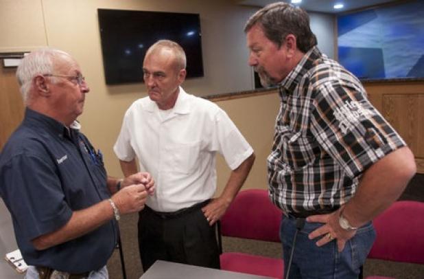 Copperas Cove City inspectyor Dan Taylor talks with Place 5 candidates George Duncan, center, and Kiby Lack following the questions and answers portion of Tuesday’s candidates forum.