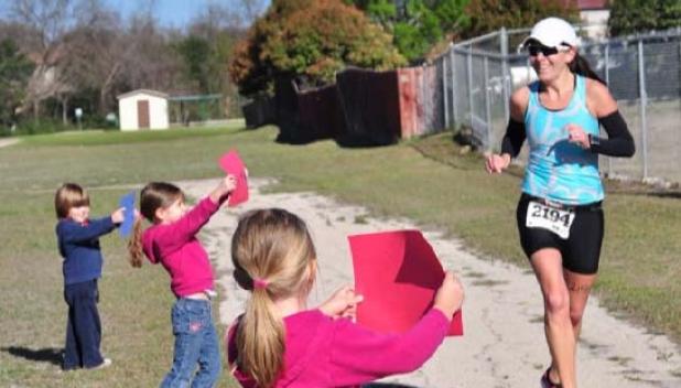 Children cheer on the runners as they make their way through South Park in Copperas Cove. The annual race will sandwich a bike race around two runs through the park with all the funds raised going to the National Multiple Sclerosis Society, Lone Star Chapter.