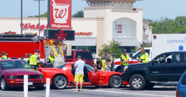 Emergency Responders try to upright an Animal Control truck and animal carrier as the accident is cleared.