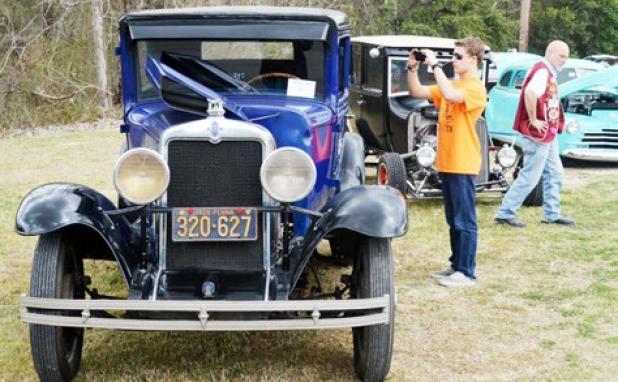 Brennan Kellum grabs a photo of the interior of a 1939 Ford at Saturday’s Moose Lodge car show.