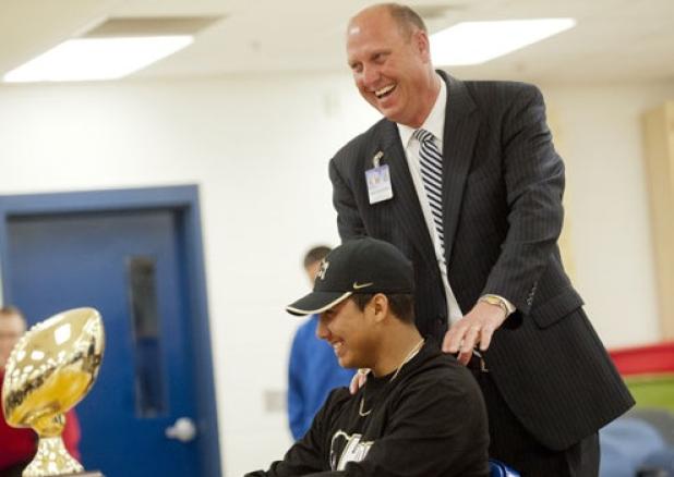 Copperas Cove’s Deputy Superintendent Rick Kirkpatrick shares a laugh with Elijah Timarky during the signing day ceremony.