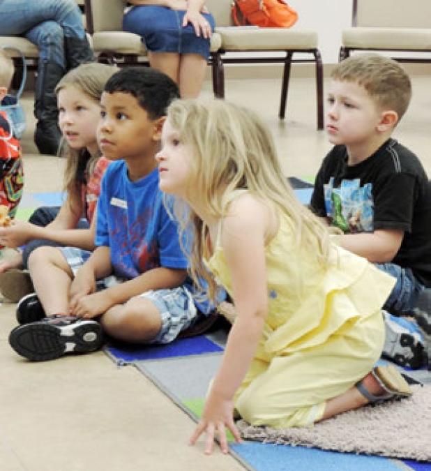 Copperas Cove Toddlers listen to a story during the Toddler Time’s Fizz Boom Summer Reading Program at the Copperas Cove Public Library.