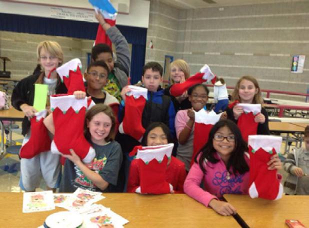 Students of the Clements-Parsons Elementary School Kids Care Club prepare to sing to residents of Hill Country Rehabilitation and Nursing Center in Copperas Cove. Students delivered stockings filled with many items to include fruit, snacks, games, cards, and toiletries.