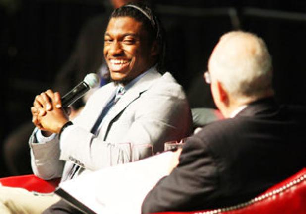 Robert Griffin III, former Copperas Cove standout, Heisman Trophy winner and current Washington Redskins quarterback, laughs as he talks with Baylor president Ken Starr during An Evening with Robert Griffin III, presented by the Gerald Bolfing Family, benefiting the Friends for Life organization, on Friday at Baylor’s Ferrell Center in Waco.