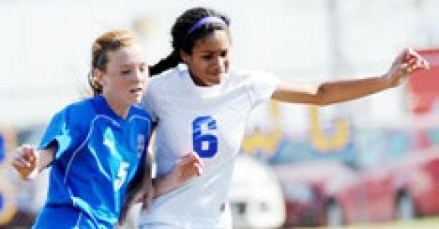 Courtney Everette pushes past a Midway defender as she moves the ball up field during Saturday’s loss.