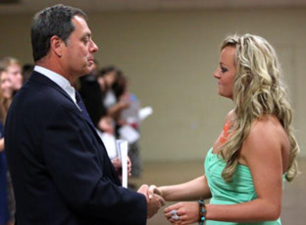 Copperas Cove senior Shelbie Letzer, right is given a certificate by assistant coach Pat Rox during the Copperas Cove soccer banquet at the Civic Center on Monday.