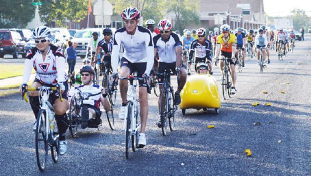 Cyclists head west on FM 1113 Saturday morning as they take off for the annual Cove House Classic.
