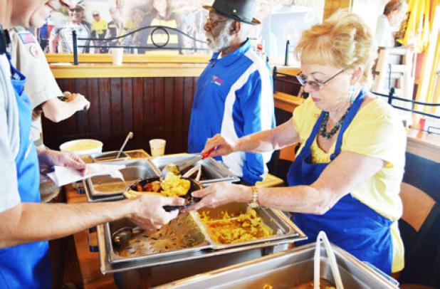 April Fitzgerald serves up eggs at Saturday’s flapjack fundraiser held by the Rotary
Club at Applebees on Saturday.