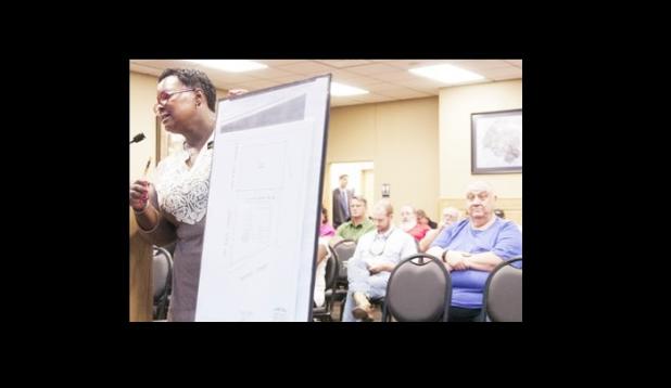 Bonnie Herrings shows the proposed site of two plots of land she hopes to have rezoned from Residential 1 to Commercial so Century 21 Premier Realtors can build a two-story office building on.