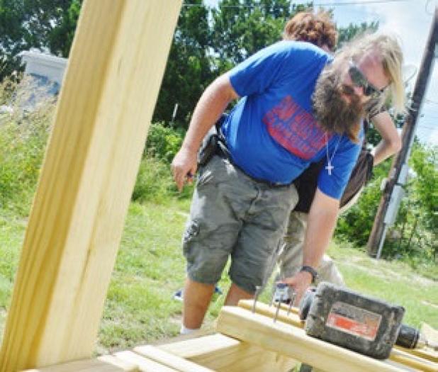 Eli Harris of Hillsboro, works on a wheelchair ramp for Sandra McLeod, of Kempner