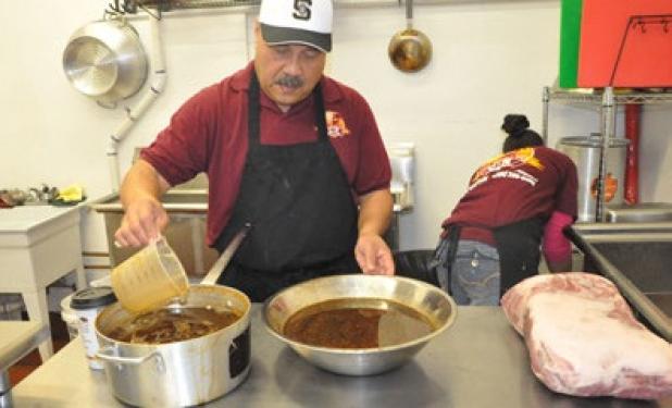 Owner Hensan Timo prepares and making his homemade Polynesian
and island sauces for the day at C&H Hawaiian Grill