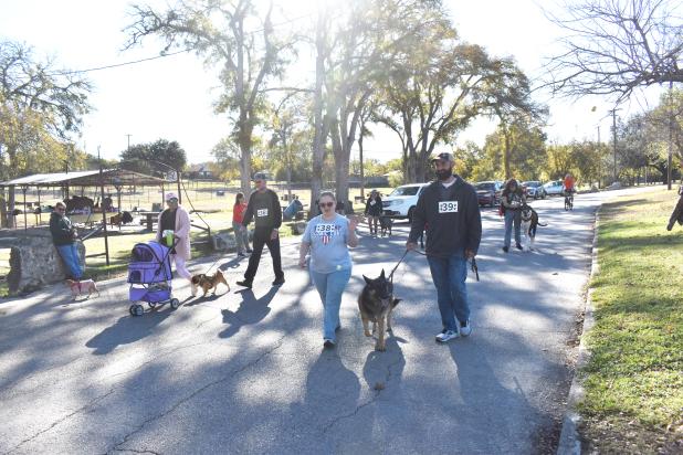 Humans and their four-legged fur friends head out along the route at the Cove Pup Fun Run & Walk 5k. This year's event is set for Nov. 22.
