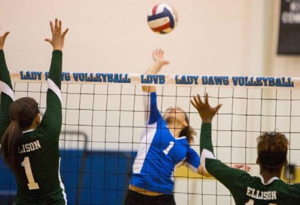 Copperas Cove senior Mikayla Blount hits between two Ellison defenders Bry Sanchez (1) and Brianna Gray during the Lady dawgs’ sweep of the Lady Eagles on Friday.