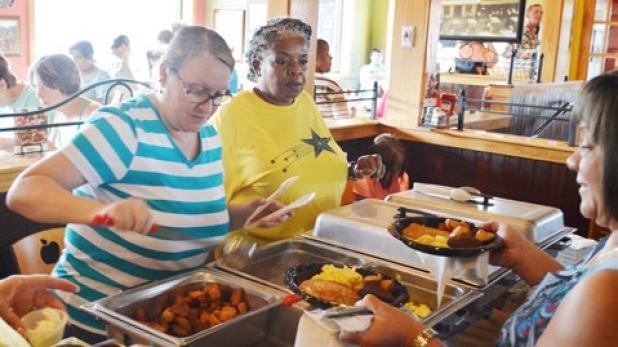 Sharon Beato and Pat Boston serve up breakfast at the CCACC flapjack fundraiser on Saturday.