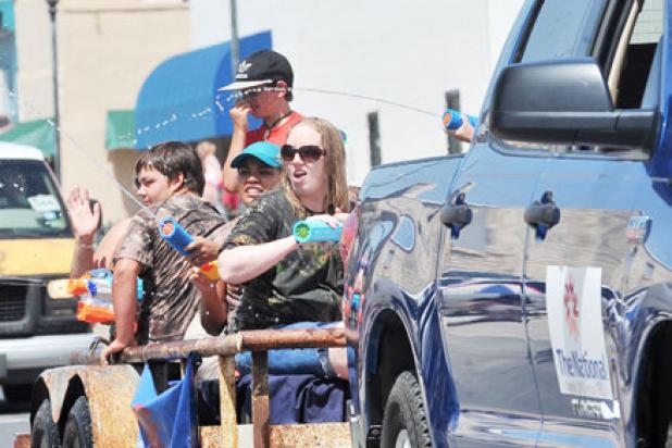The National Banks of Central Texas spray water on the parade spectators. The interactive parade offers a refreshing break thanks to the springs of Lampasas