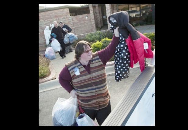 Copperas Cove Junior High Communities in School advisor Stacy Bradley loads a handful of jackets into her vehicle after collecting them from Holy Family Catholic Church.
