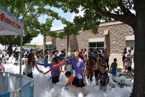 Children enjoy playing in the bubbles at the kickoff for the library’s annual Summer Reading Program on Tuesday afternoon. 