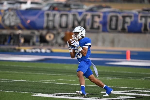 Bulldawgs run the field with the ball on Friday evening. 