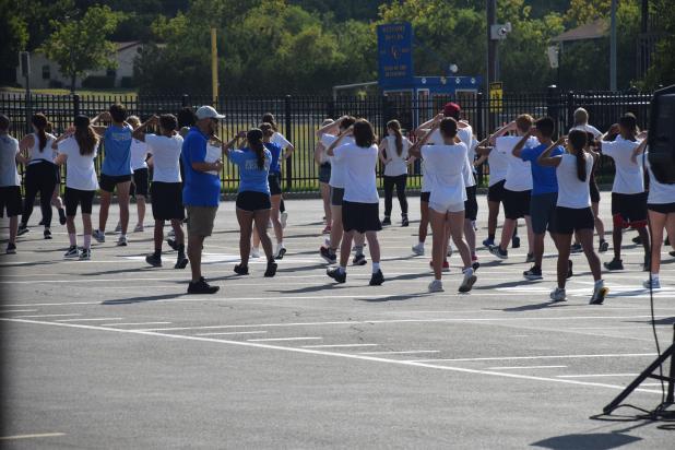 Mario Morales, Director of Instrumental Music for CCISD, puts the band students through their paces on Monday afternoon at the CCHS parking lot. 
