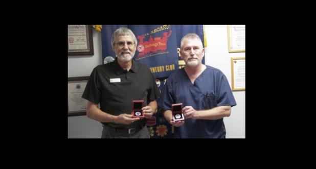 Gary Kafer, left and J.D. Sheffield hold their Morning Exchange Club of Copperas Cove coins following Sheffield’s presentation regarding his recent visit to the Mexico/Texas border.