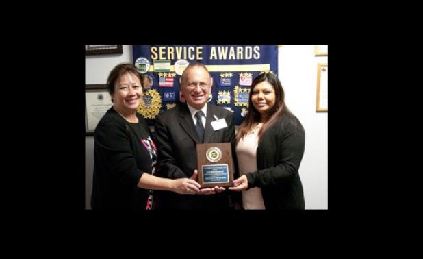 Chamber President Betty Price, left, and Exchange Club member Joe DeCroce, center, present Liz Sherman with her employee of the quarter award.