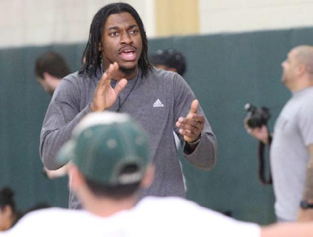 Heisman Trophy winner, NFL quarterback and Former Bulldawg Robert Girffin III encourages children as they do jumping jacks during the ‘Salute to Fitness’ Satuday at Baylor’s Ferrell Center. Griffin’s foundation ‘Family of 3’ formed to help military families and children in need, hosted the event.