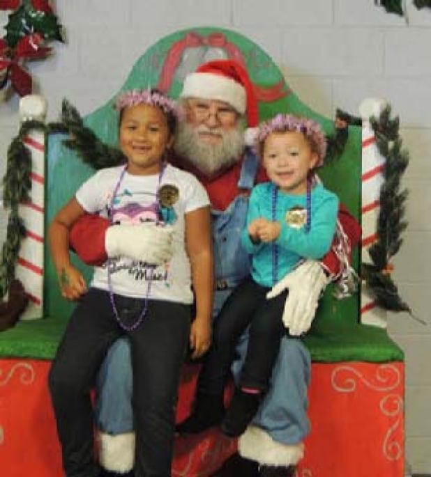 Santa poses for photos with children during the annual Christmas on the Farm celebration in Belton.