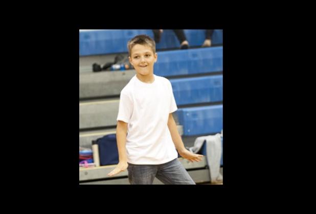 Ryan Boucher dances to the music as he performs with the Cougar Band, Tuesday.
