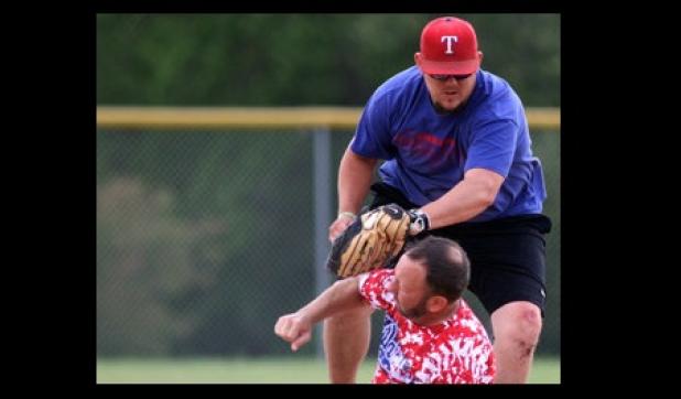 Bo Scribner of the Jokers/Southern Nights team tags out Nick Valentine of the Fort Hood Warriors during the men’s division championship game of the 2014 Rabbit Fest Softball Tournament on Sunday at Copperas Cove City Park.